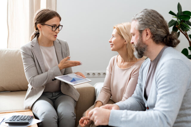 Mature couple being counselled by financial advisor.