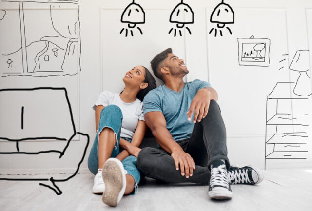 Young couple sits against white background amongst drawings of different home features.